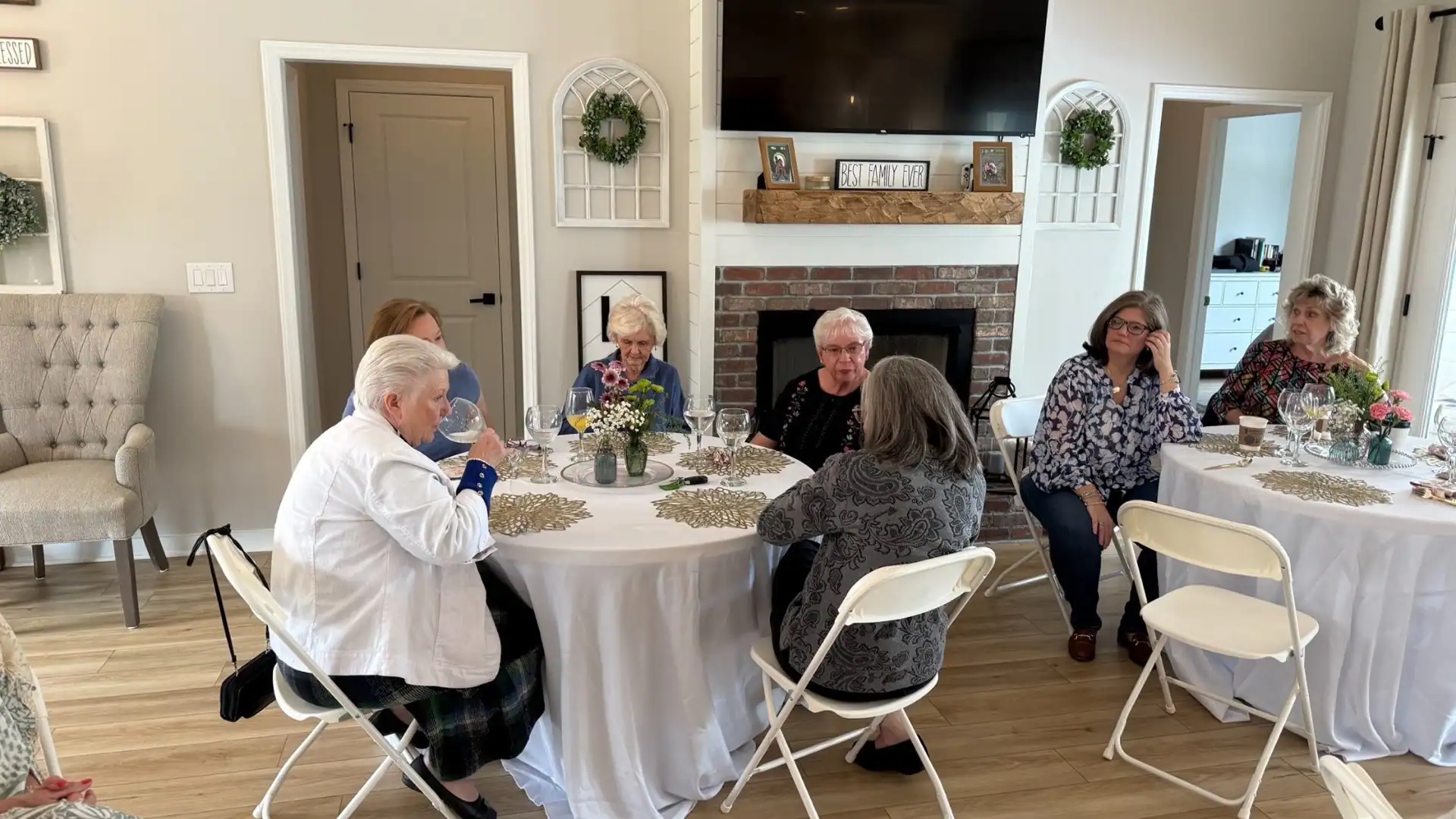 Women gathered around flower-decorated tables for fellowship